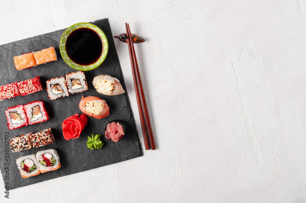 Japanese cuisine. Assorted sushi maki gunkan roll on white table