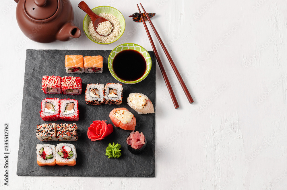 Japanese cuisine. Assorted sushi maki gunkan roll on white table