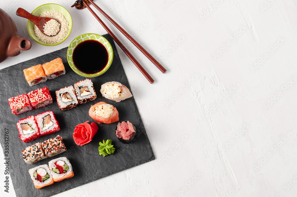 Japanese cuisine. Assorted sushi maki gunkan roll on white table