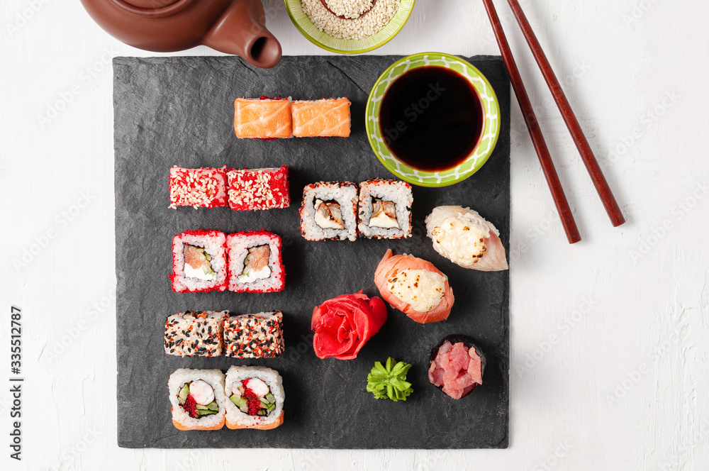 Japanese cuisine. Assorted sushi maki gunkan roll on white table