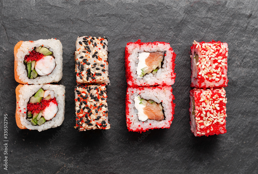 Japanese cuisine. Assorted sushi maki gunkan roll on white table