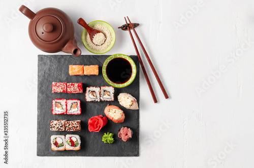 Japanese cuisine. Assorted sushi maki gunkan roll on white table