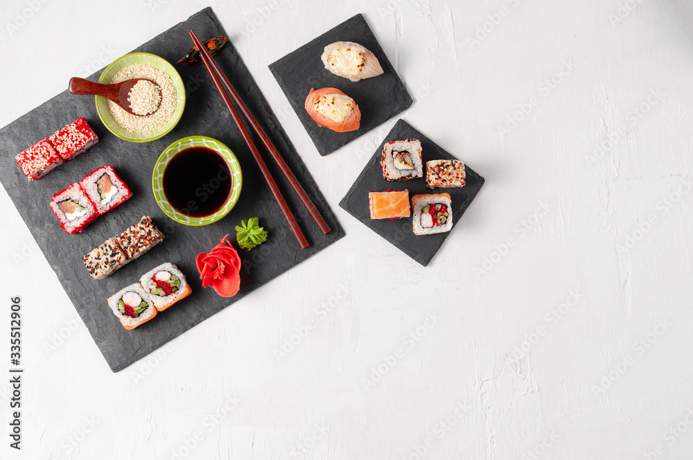 Japanese cuisine. Assorted sushi maki gunkan roll on white table