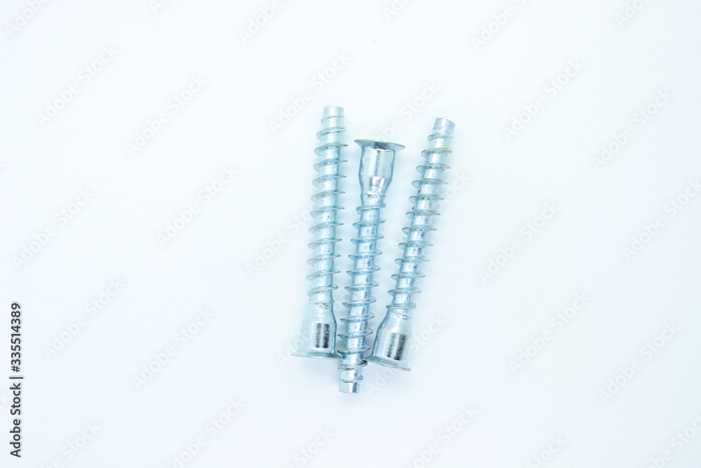 White metal screws located on a white background