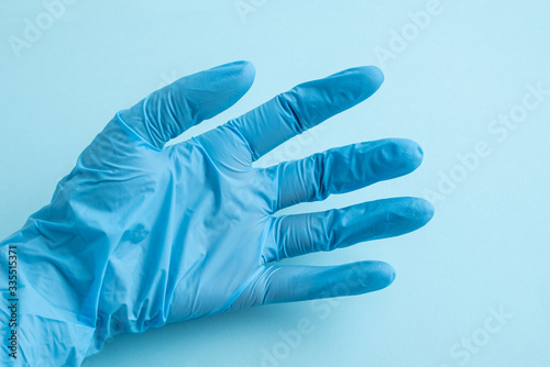 Medical staff hands wearing blue disposable gloves