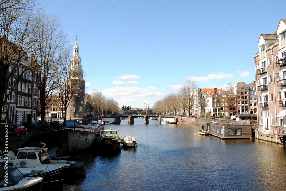 View on the Montelbaanstoren, a tower on the bank of the Oudeschans canal in the citycenter, built in 1516 as part of the Walls of Amsterdam defending the city and the harbour; National Monument