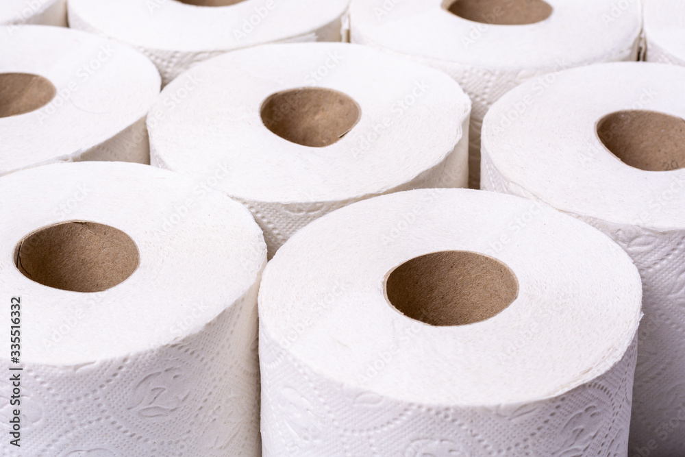 Piled up toilet paper rolls close up from the front at an angle Piled up toilet paper rolls close up from the front at an angle