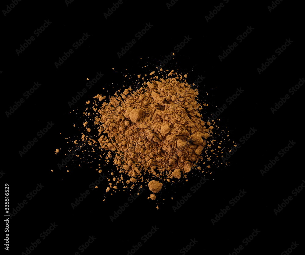 Cocoa powder isolated on black background, top view