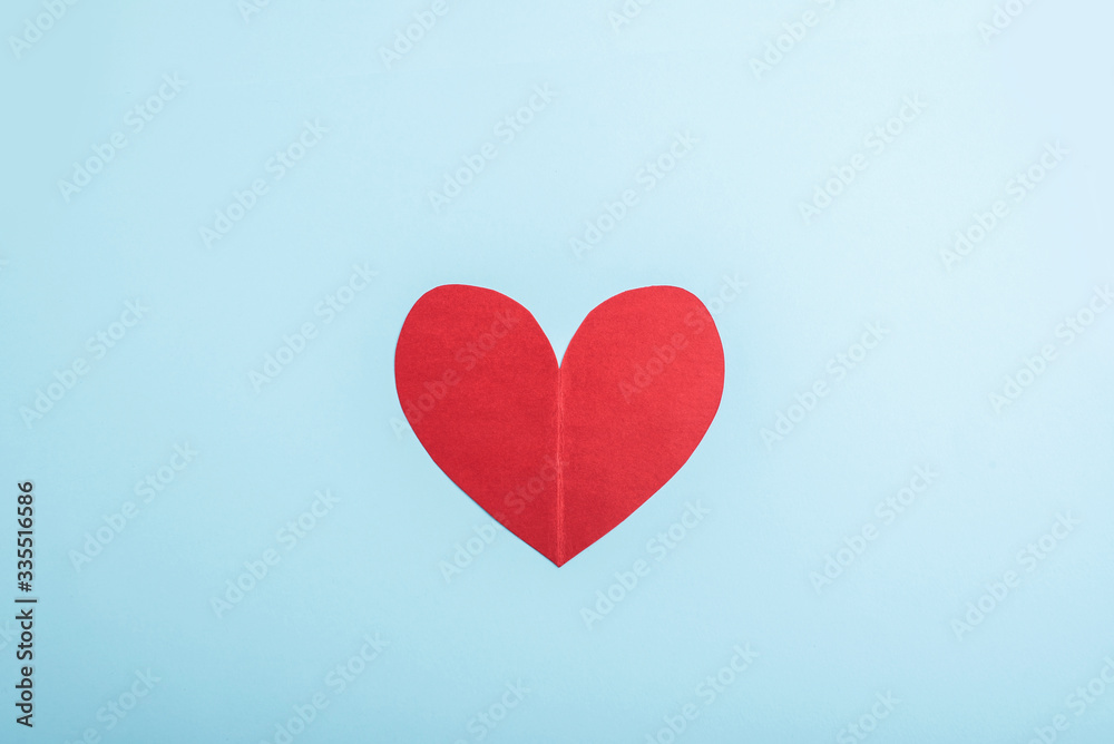 A red heart on a light blue background