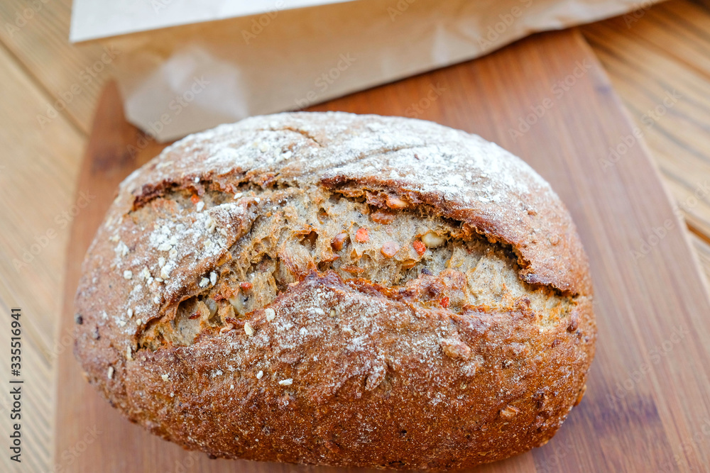 Carrot bread on a cutting board. Uncut loaf of bread. Home-made, eco-friendly product