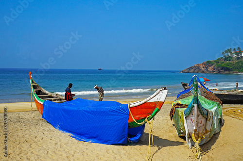 Fishing boats on the beach near Kovalam city of Kerala, India