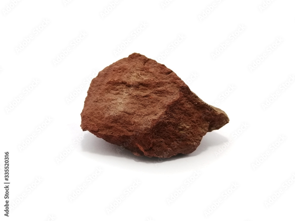 Red shale specimen on white background. Shale is a fine-grained, clastic sedimentary rock.
