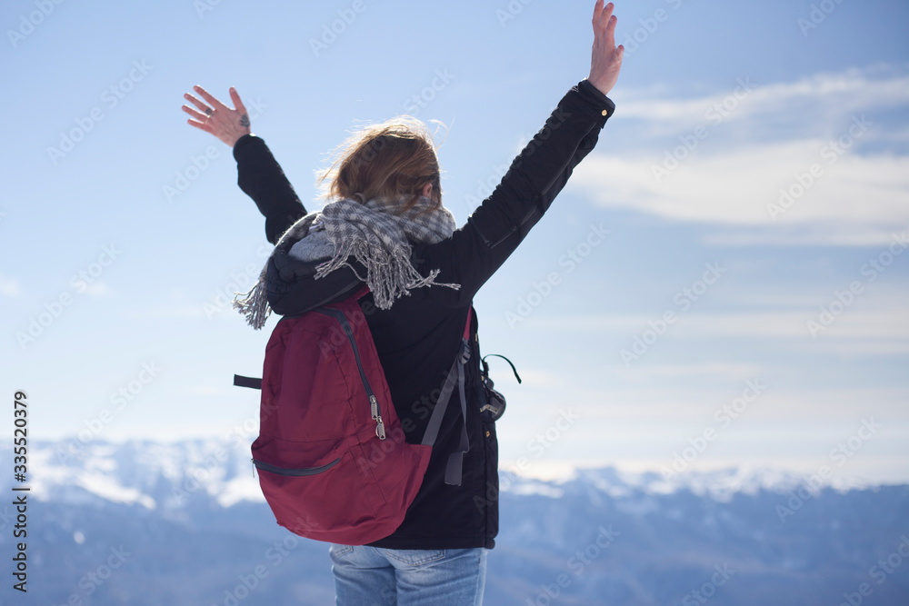 Girl on the mountain raises her hands. Girl on the mountain raises her hands.