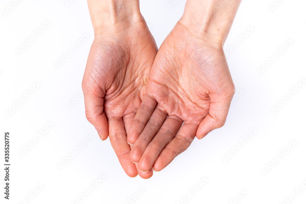 Woman holds hands out on white background from the top