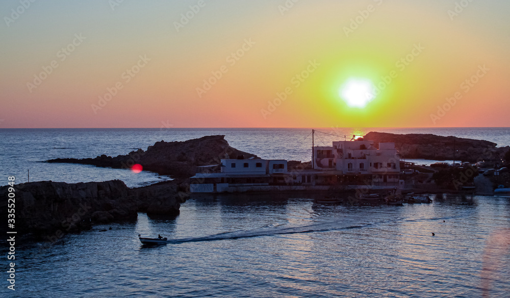 sunset in a greek bay small village