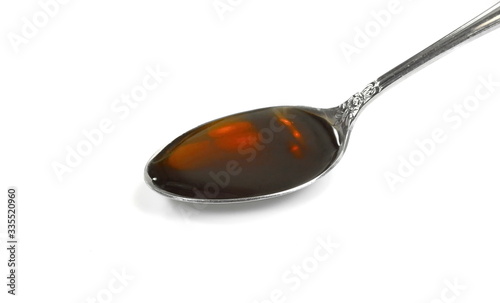 Spoonful of Cough Medicine isolated on a white background. medication or antipyretic syrup. 