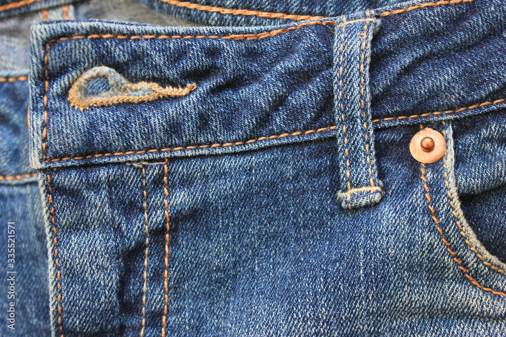 Unbuttoned denim jeans close up. Classic stylish blue jeans with undone button hole, casual pants fashion design. Classic denim jeans material, top view image Unbuttoned denim jeans close up. Classic stylish blue jeans with undone button hole, casual pants fashion design. Classic denim jeans material, top view image