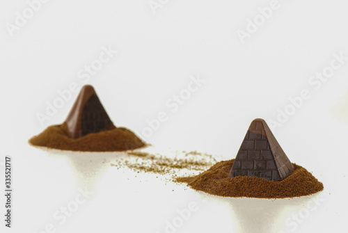 Creative dark brown chocolate pralines shaped like Pyramids