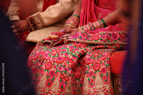 Indian wedding ceremony : bangle in bridal hand with mehandi design © Neha