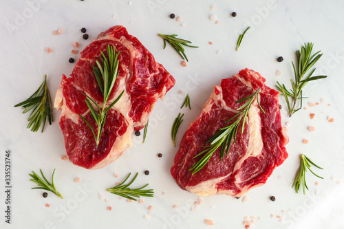 Tasty fresh beef steaks on light background