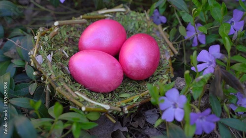 Painted eggs for easter. PINK EGGS on a background of flowers