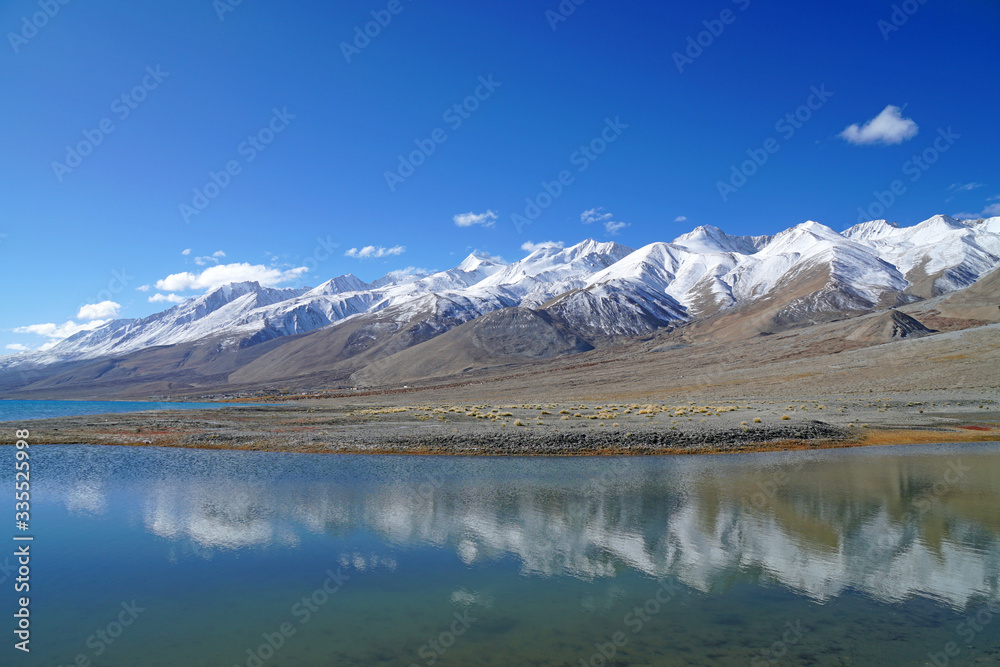 Nature Scene of Landscape Pangong tso or Pangong blue Lake with mountain background at Leh Ladakh ,Jammu and Kashmir , India - Travel and Sightseeing                               