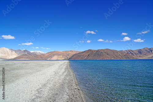 Nature Scene of Landscape Pangong tso or Pangong blue Lake with mountain background at Leh Ladakh ,Jammu and Kashmir , India - Travel and Sightseeing 