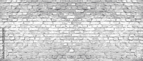 White washed old shabby brick wall wide texture. Large light gray rustic bric...