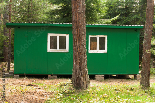 Green bungalow in the forest © Deyan Georgiev