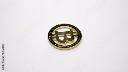 Golden Bitcoin coin rotates on a white background. Footage. 360 rotation.