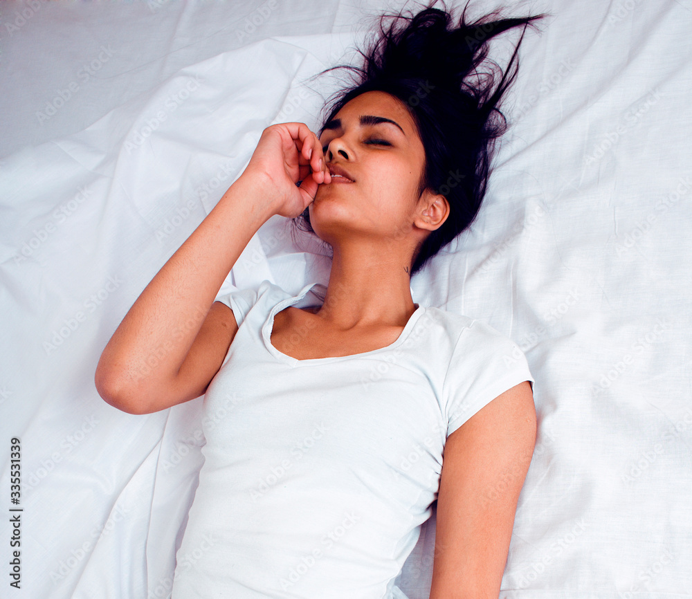 pretty brunette indian woman in bed, cant sleep, lifestyle real modern people close up pretty brunette indian woman in bed, cant sleep, lifestyle real modern people close up