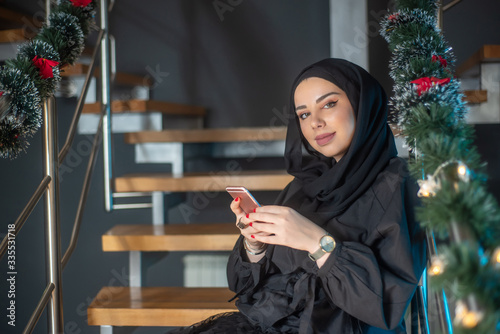 Beautiful two girls with hijab hanging out, typing on laptop, learining about photography and study photo