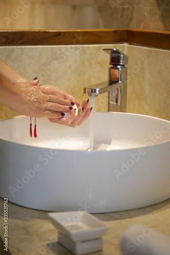 Hygiene. Cleaning hands with soap and water. Washing hands on sink. Preventing diseases by washing your hands.	