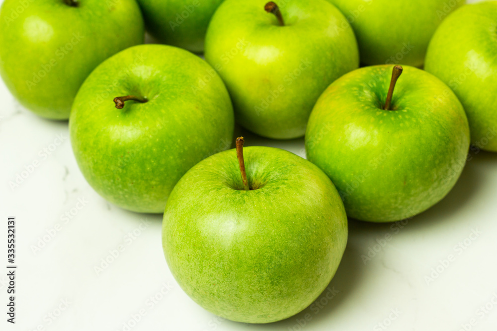 fresh green apples on a white background close-up
