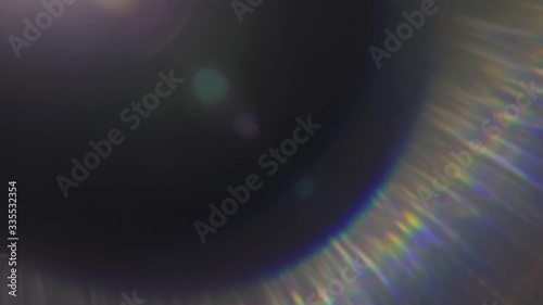 Beautiful abstract defocused lens flare on a dark background. Real light leaks and lens flare.