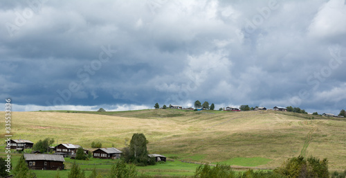 Siberian village on the hills on a cloudy day. Russia