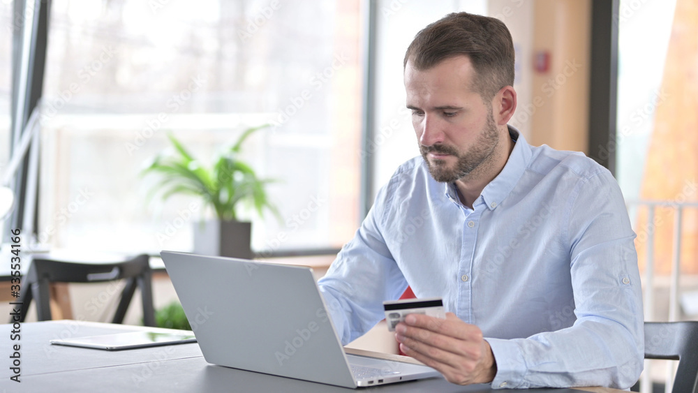 Online Payment by Young Man on Laptop in Office Online Payment by Young Man on Laptop in Office