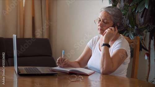 Coronavirus self isolation woman with medical mask spraying antibacterial gel 