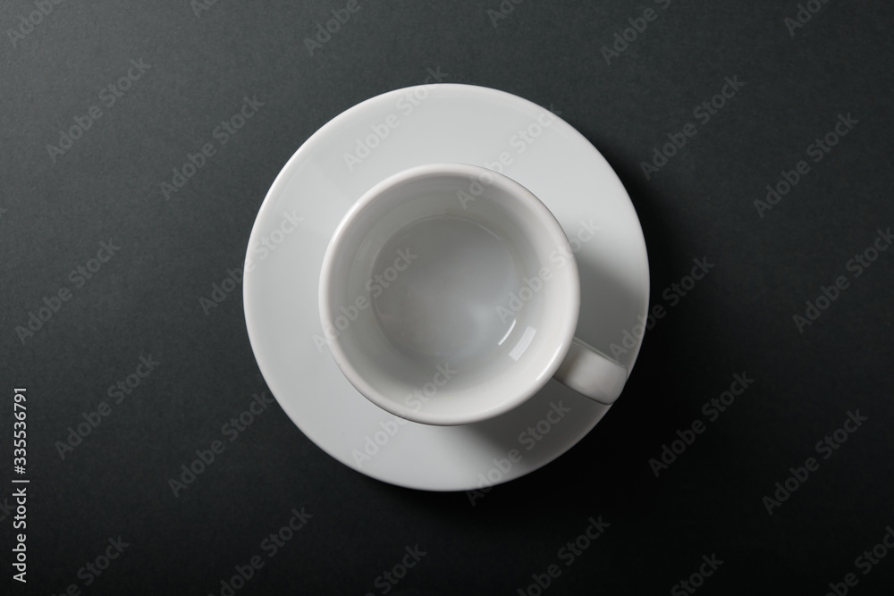 White cup for coffee on a dark background, top view White cup for coffee on a dark background, top view