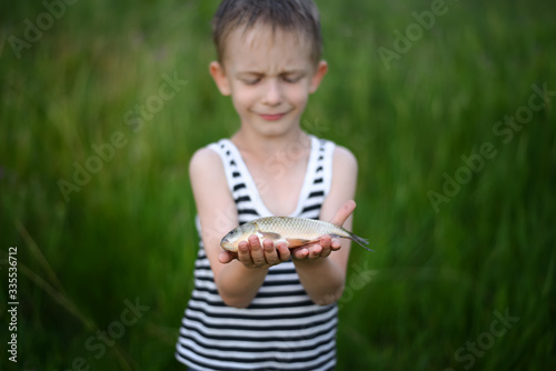 boy is feeling pity of fish photo