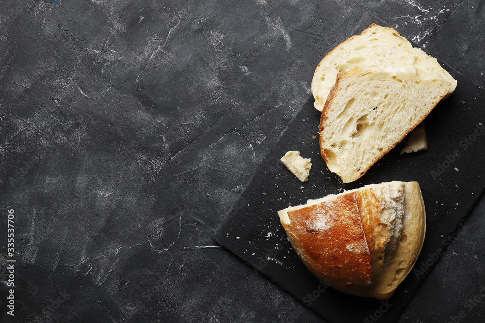Sliced fresh white bread on a dark table Sliced fresh white bread on a dark table
