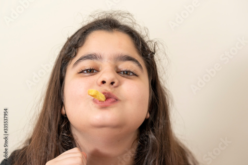 young girl eats french fries