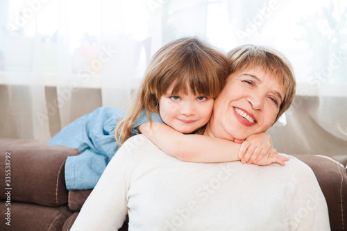 Happy middle-aged mature grandma and  little preschooler granddaughter having fun playing at home. Quality Time. Family having fun playing at home. stay home concept © ulza