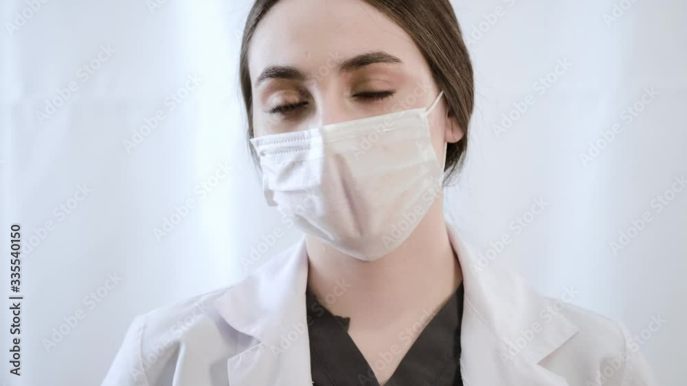 Woman doctor speaking with mask while looking at camera. Without sound.