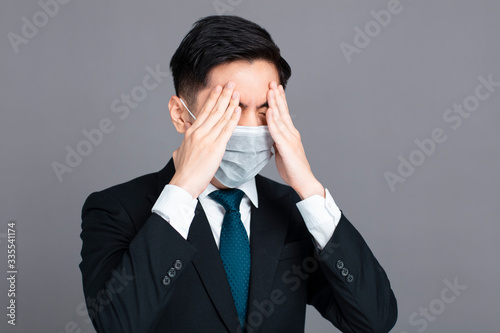 young man wear medical mask and headache concepts