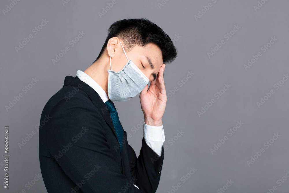 young man wear medical mask and headache concepts young man wear medical mask and headache concepts