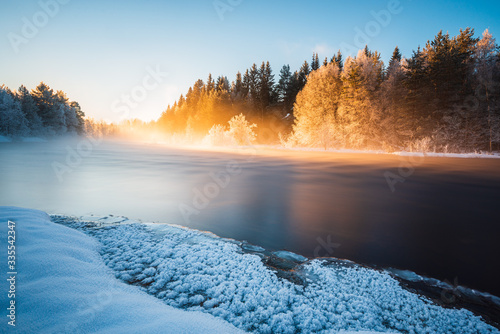 Misty morning by the river in winter