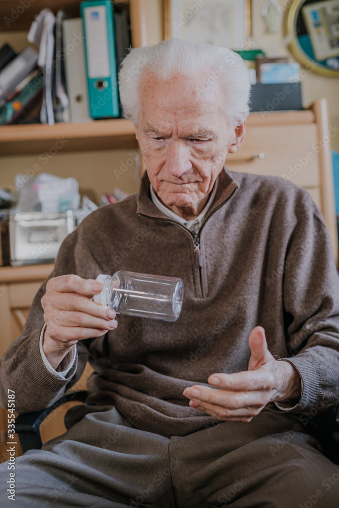 Senior holding an empty medicine bottle Senior holding an empty medicine bottle