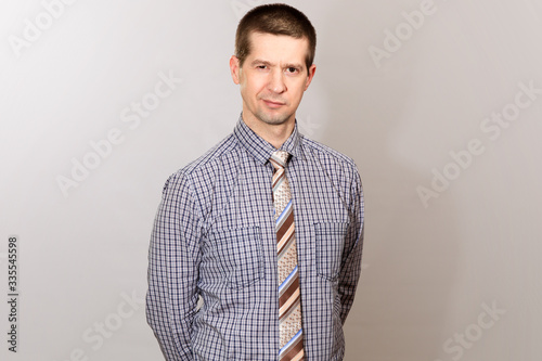 A belt portrait of an employee wearing a cage shirt and tie. Isolated
