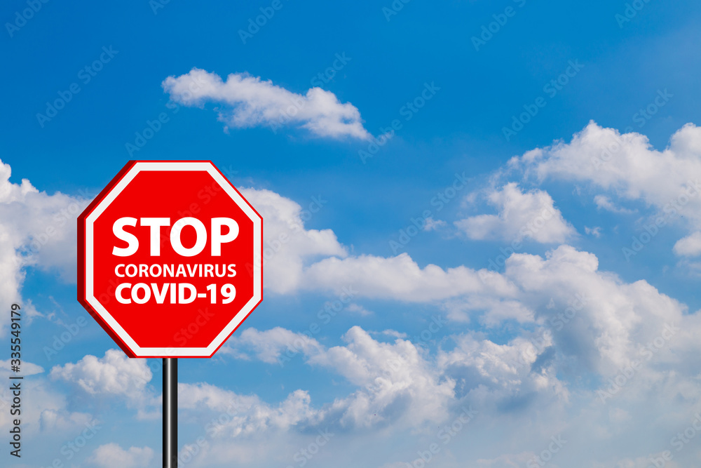 Stop warning sign coronavirus covid 19 in blue sky background Stop warning sign coronavirus covid 19 in blue sky background